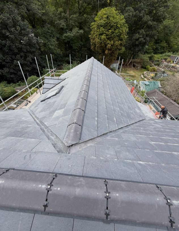 Natural slate hip roof with dry-fix ridge