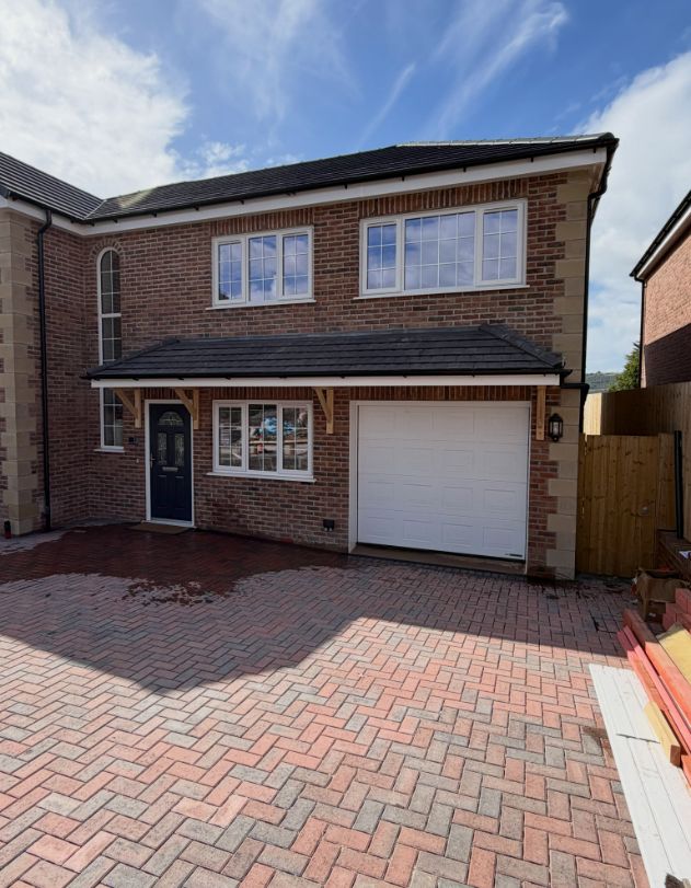 New-build brick home with tiled roof and canopy
